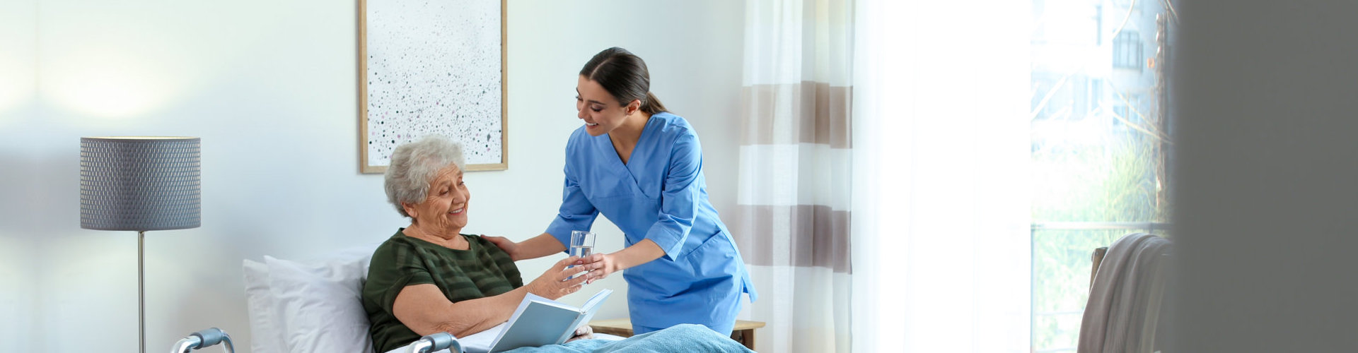 caregiver serving a glass of water to her patient